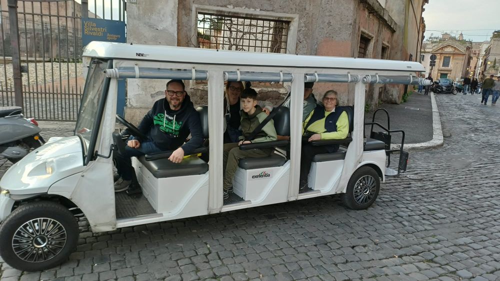 Golf cart stop by Piazza del Popolo as the guide highlights hidden details.