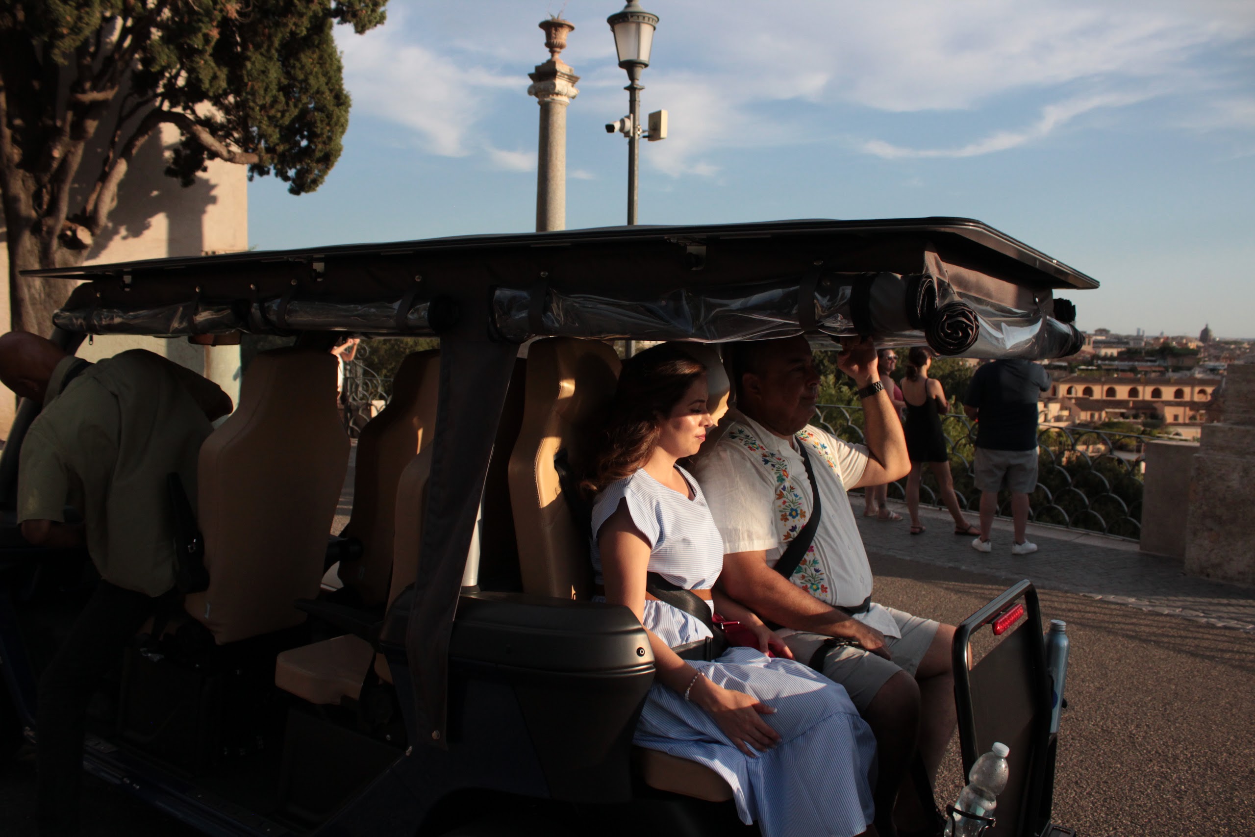 Guests in a golf cart near the Spanish Steps at sunset