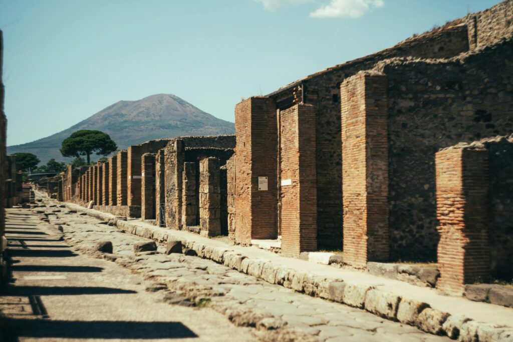 Colonnade in ancient Pompeii with Vesuvius behind it