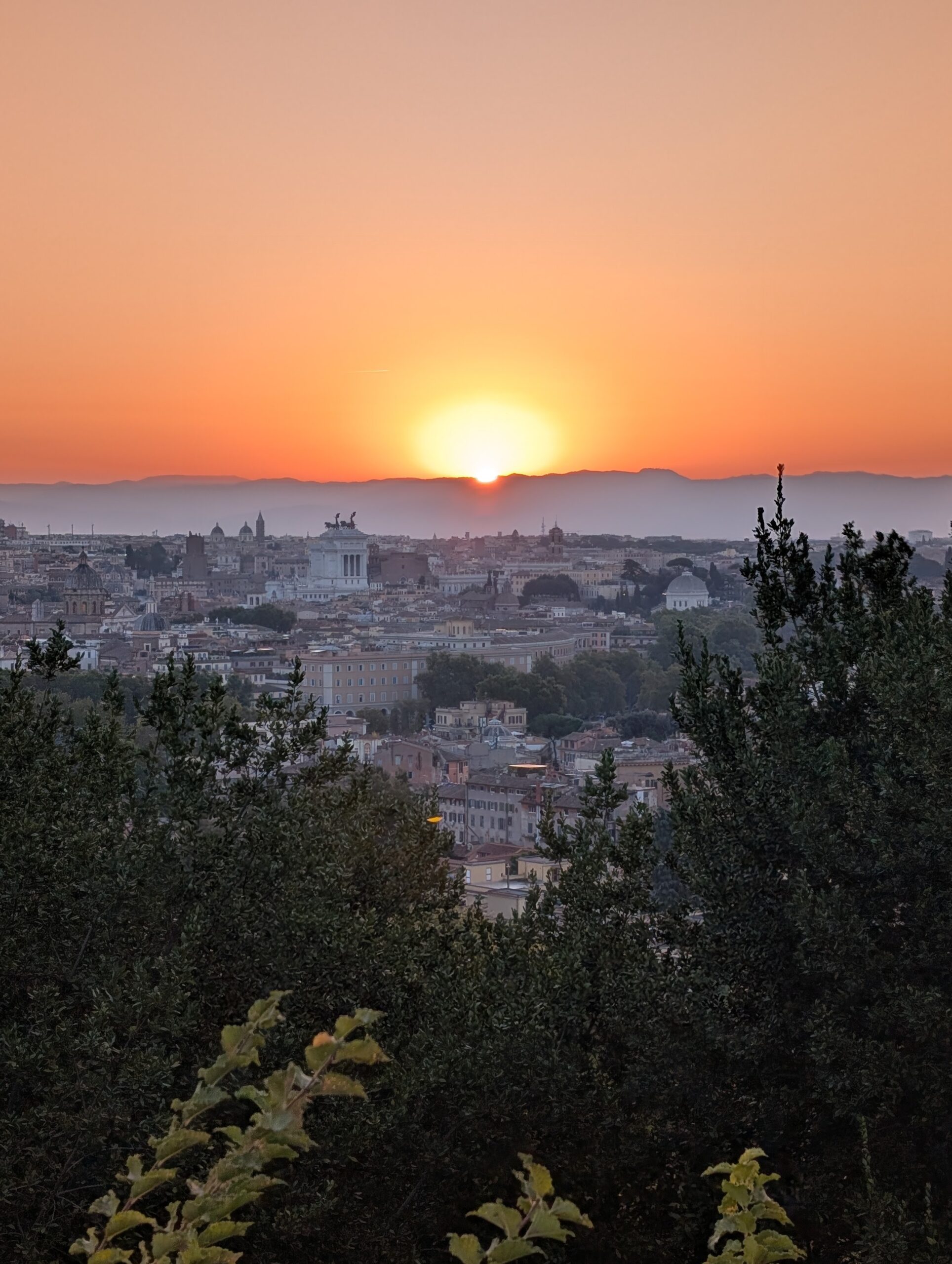 The sun rising over the domes of Rome