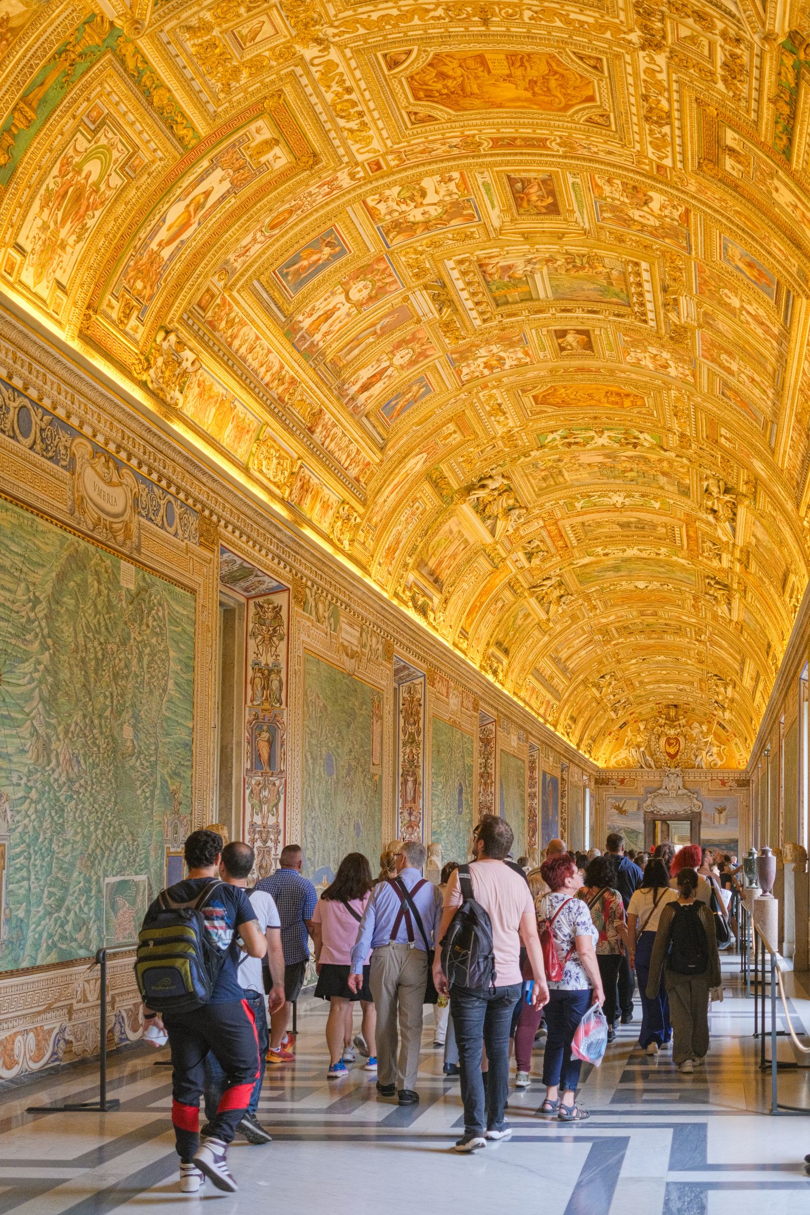 Visitors walking through the Gallery of Maps in the Vatican Museums